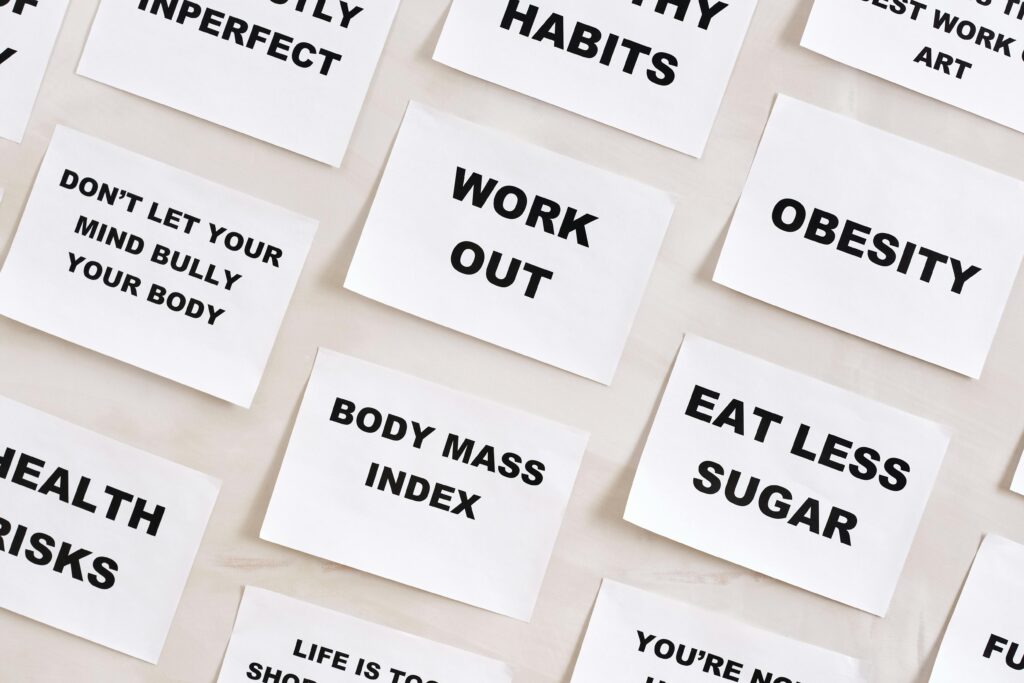 Flat lay of motivational health quotes on paper, promoting healthy habits and self-care.